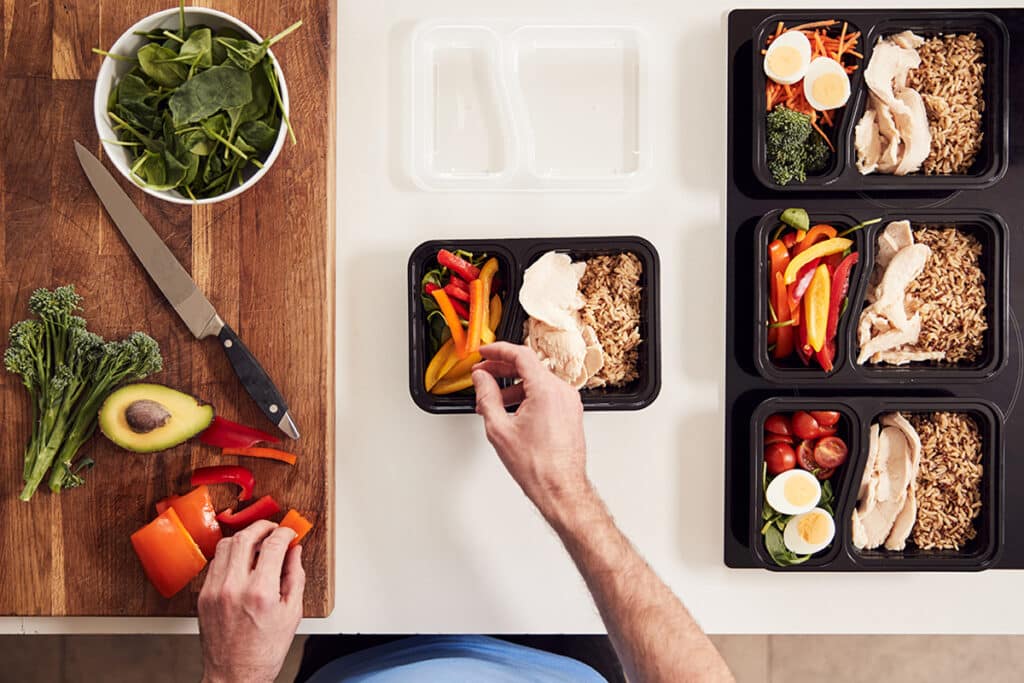 man prepping chicken and rice