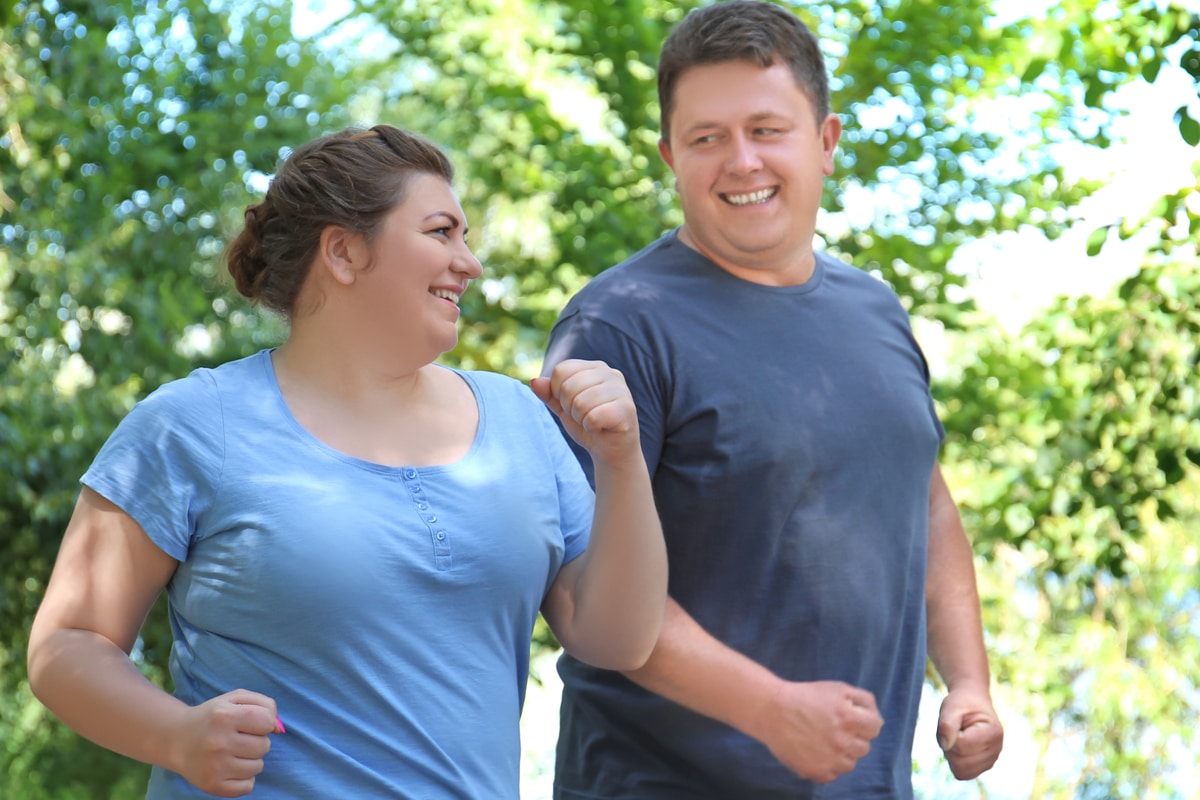 couple walking together outside to get some exercise and build muscle