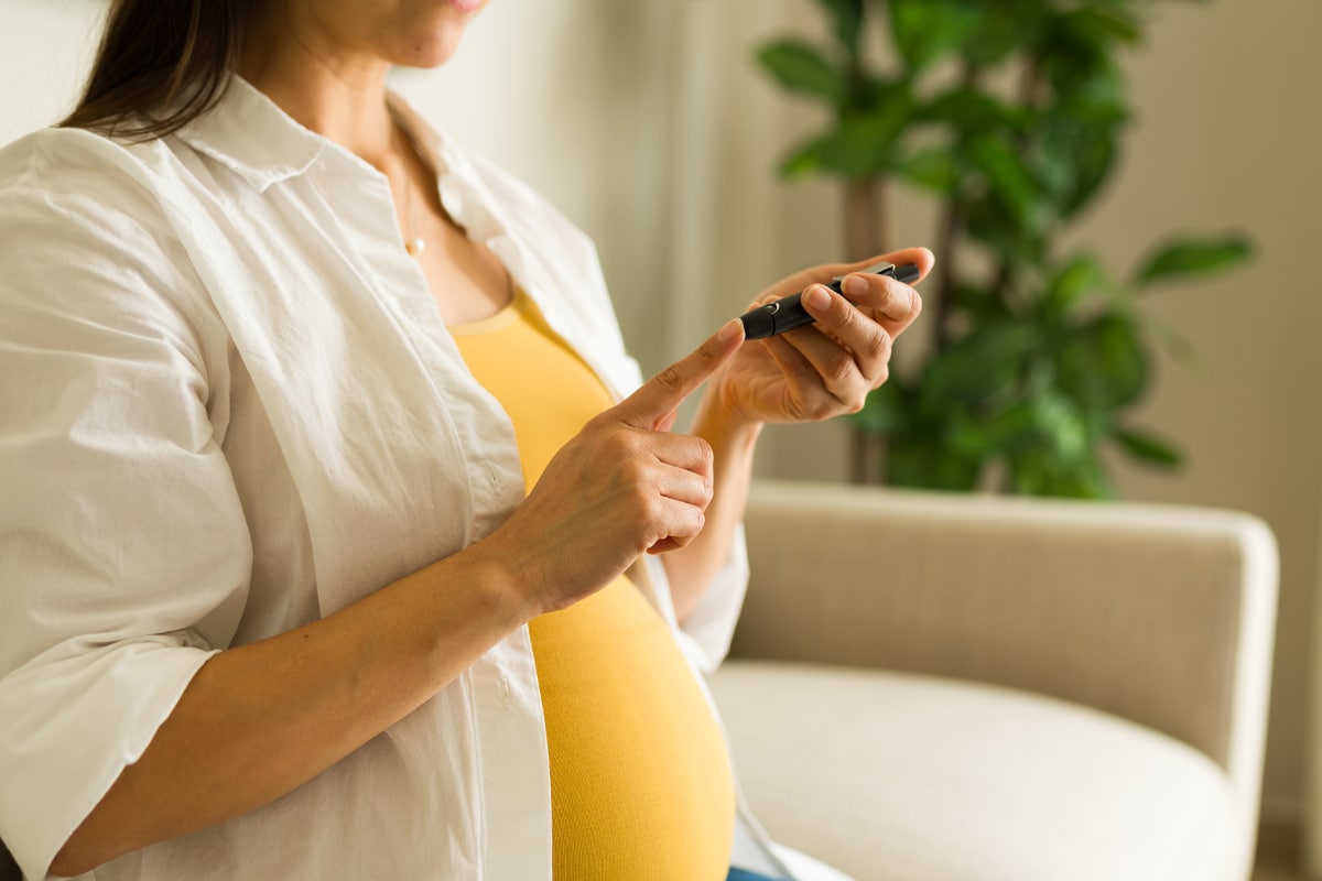 gestational diabetes - pregnant woman checking blood sugar