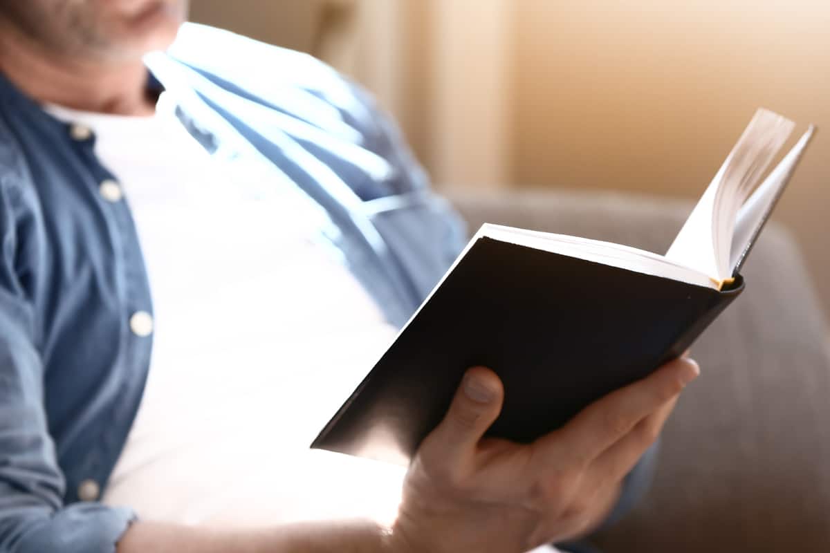 triggered eating redirect - man reading a book practicing mindful eating